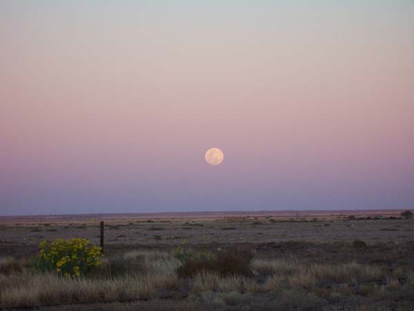 Full moon rising at sunset