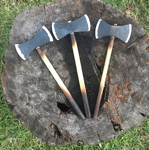 A set of mini double bit axes made from a 4wd coil spring.